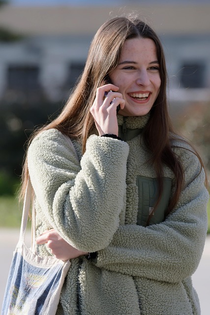 スマートフォンで通話をしながら笑顔を見せる女性